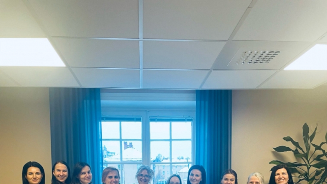 Kolektīvs telpā pie loga