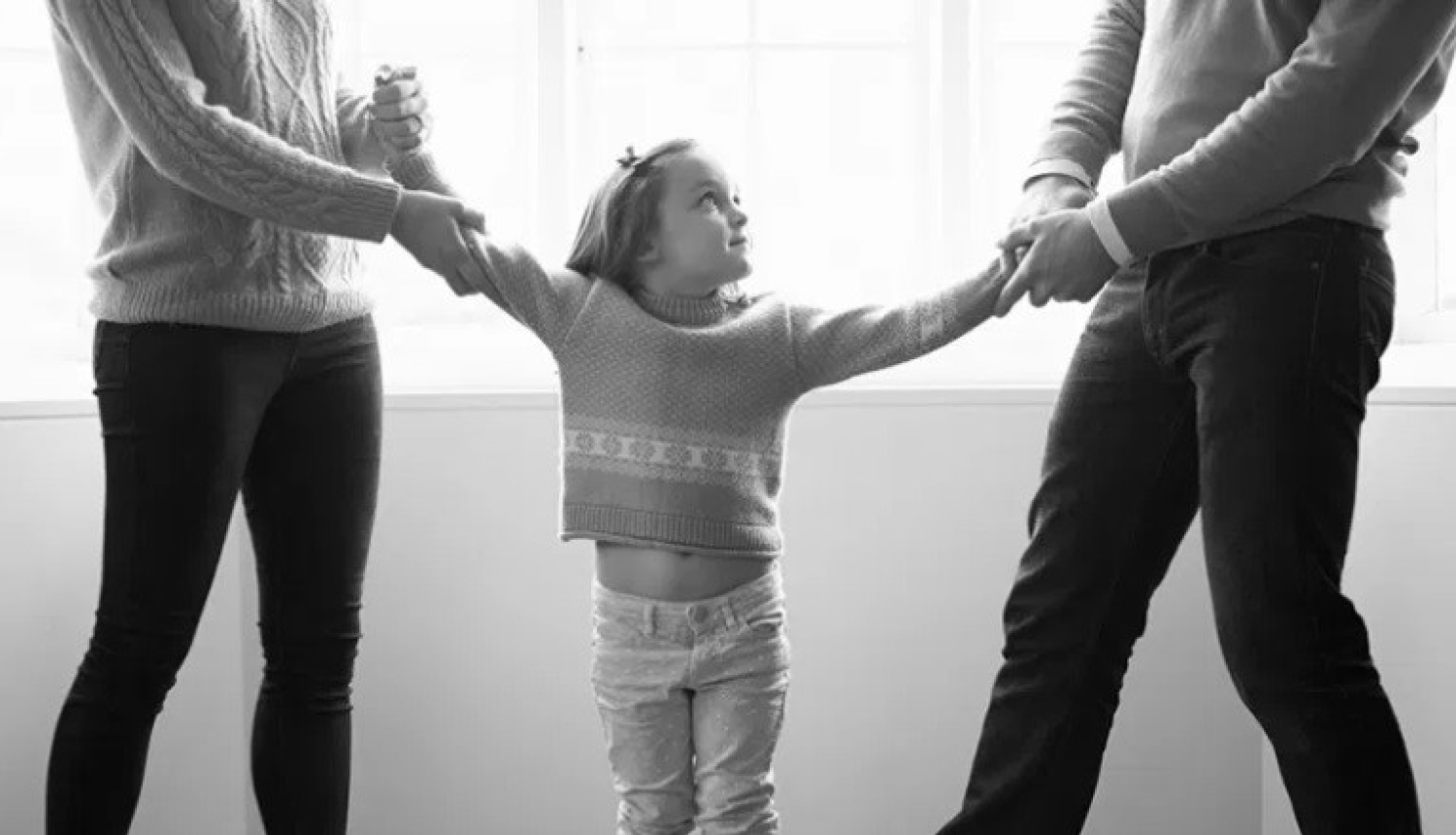 bērns starp diviem cilvēkiem